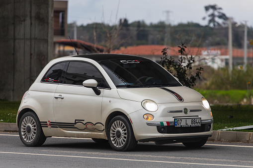 Side; Turkey – March 03 2022:   white Fiat 500  parked on the street on a warm summer day