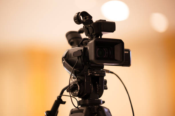 istock Video camera operator Professional camera filming a video podcast 1388293600