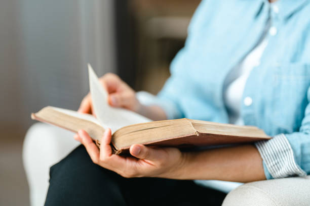 istock Close up Woman hand open book and reading for education 1388294912