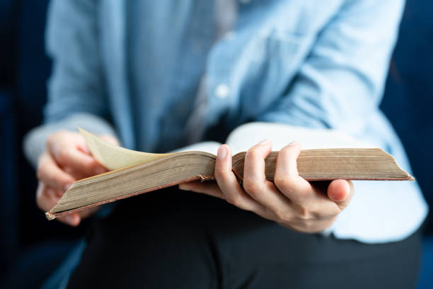 istock Close up Woman hand open book and reading for education 1388295224