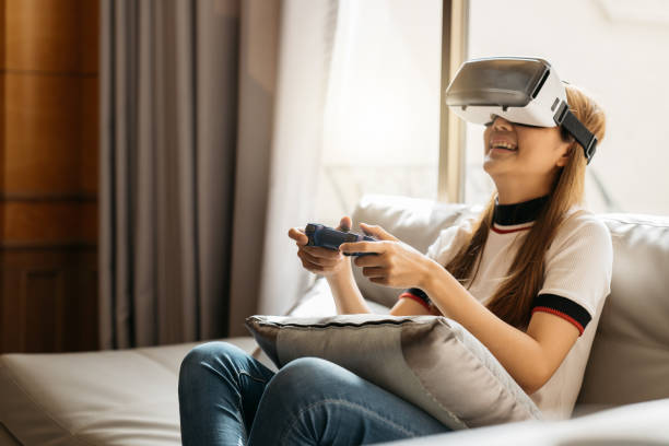 istock Woman play the video game with virtual reality device 1388296483