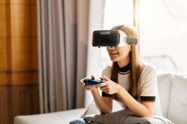 istock Woman play the video game with virtual reality device 1388297068