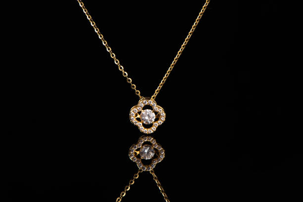 istock golden pendant with chain on black background 1388297096