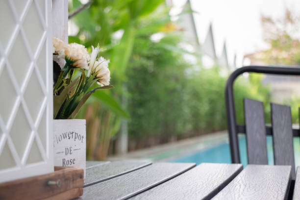 istock Empty table top and blurred swimming pool in tropical resort 1388297992