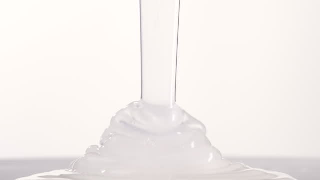 White gel liquid pouring on white background