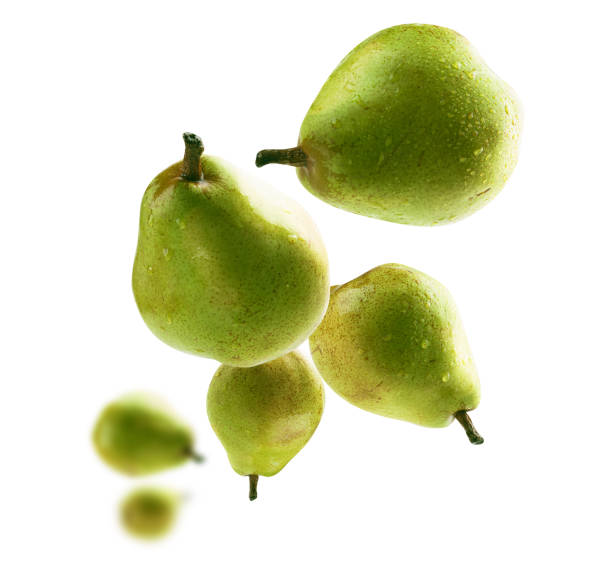 istock Green pears levitate on a white background 1388301007