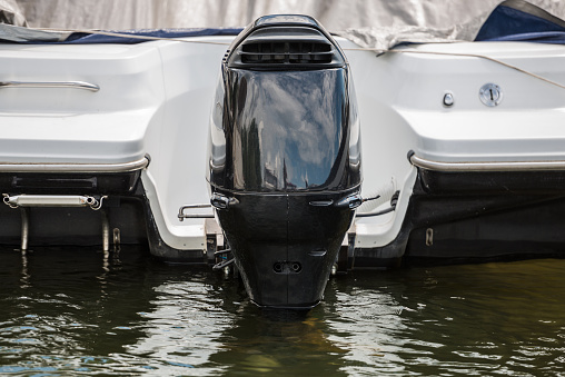 Large black outboard motor of a yacht, close-up