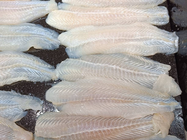 istock Fresh fish fillets sliced on a black tray 1388302312