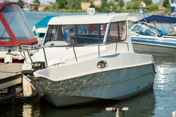 white motorboat moored at the river pier