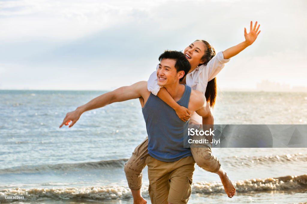Husband Carrying Wife On Back On A Summer Beach Stock Photo Stock Photo Husband Carrying Wife On Back On A Summer Beach Stock Photo Stock Photo