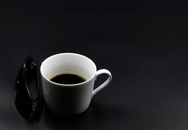 istock Cup of coffee next to sunglasses 1388311057