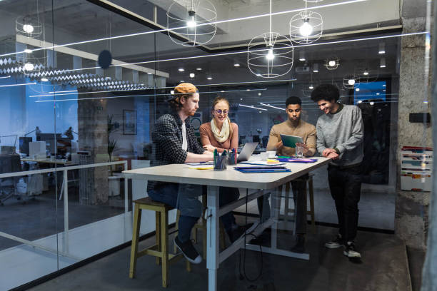 istock Young creative people working on wireless technology at casual office. 1388311663