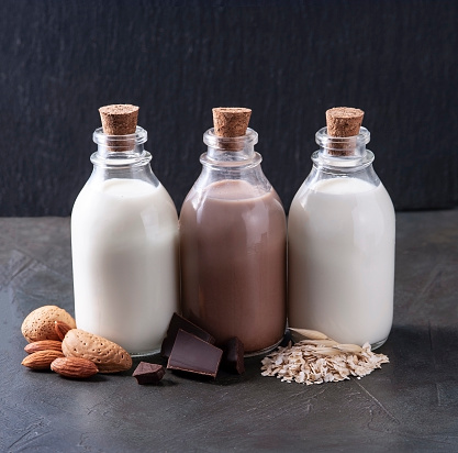 Vegan milk. Almonds milk, chocolate milk and milk of oats closeup. Healthy food.