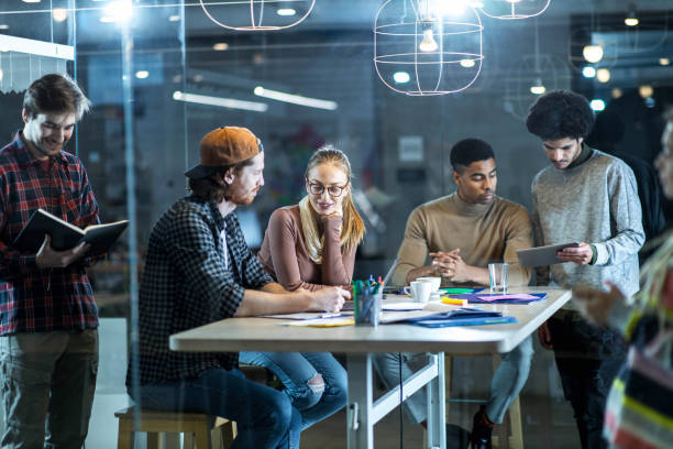 istock Large group of multi-tasking freelancers working in the office. 1388311832