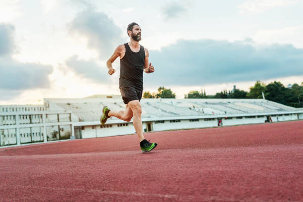 istock Man running on the track to keep fit 1388312162