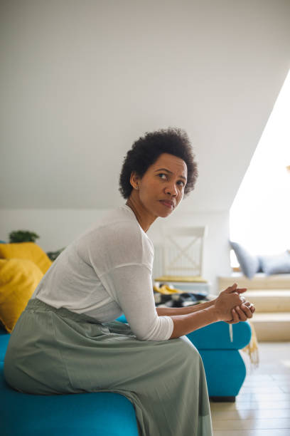 istock Woman looking over shoulder, contemplating solutions while battling negative emotions 1388314446