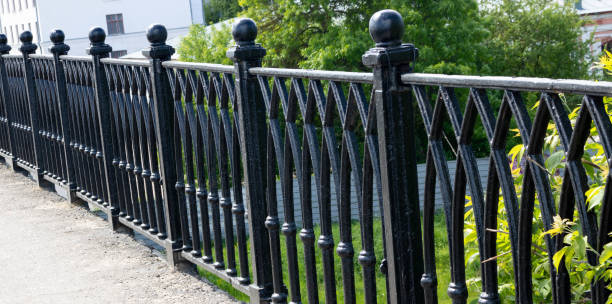 istock Black forged fence on a granite base 1388315442