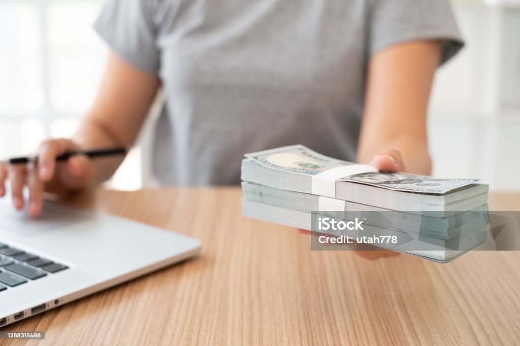 money loan money loan, revenue insurance, income compensation concept. women cashier giving money banknote to employee. Giving Stock Photo