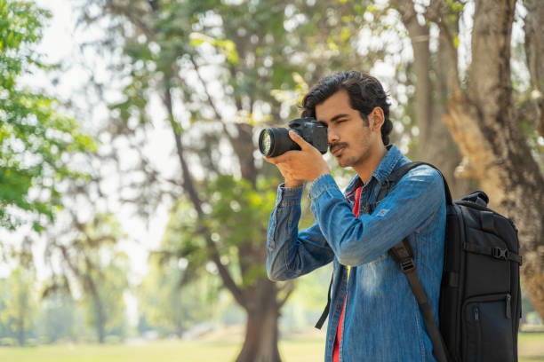 istock Young photographer taking photos with the camera 1388316811