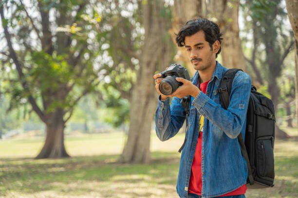 istock Young photographer checking photos in the camera 1388316814