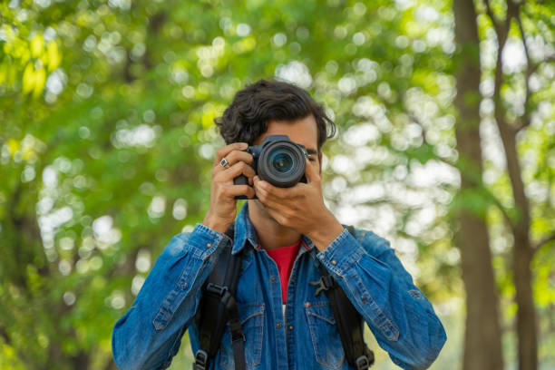 istock Young photographer taking photos with the camera 1388316819