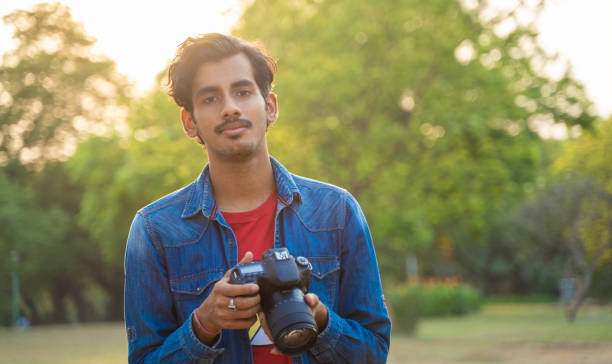 istock Young Indian photographer with his professional camera 1388316827