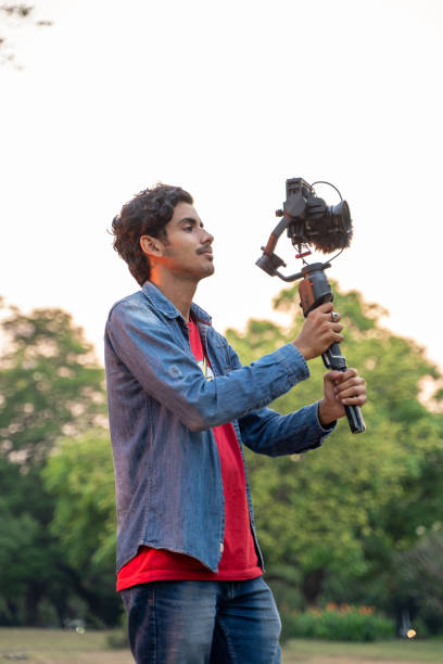 istock Young Asian vlogger with the camera. Internet influencer or content creators. 1388316886