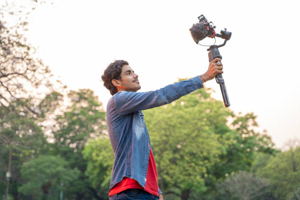 istock Young Asian vlogger with the camera. Internet influencer or content creators. 1388316901