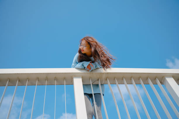 istock A beautiful asian girl leaning on a railing 1388317929