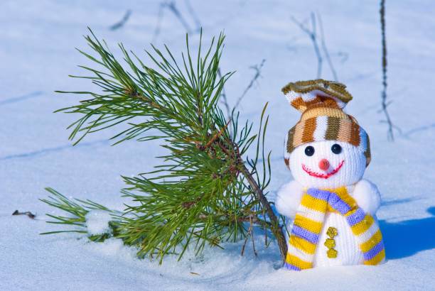 istock happy snowman on a fir tree background 1388318474