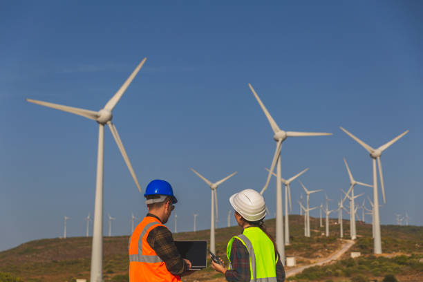 istock Young maintenance engineer team working in wind turbine. 1388319193