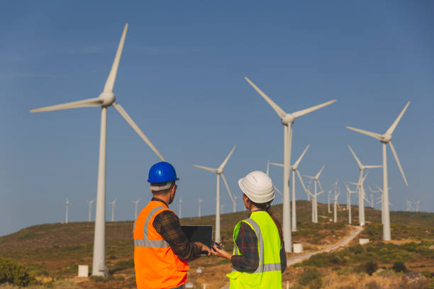 istock Young maintenance engineer team working in wind turbine. 1388319221