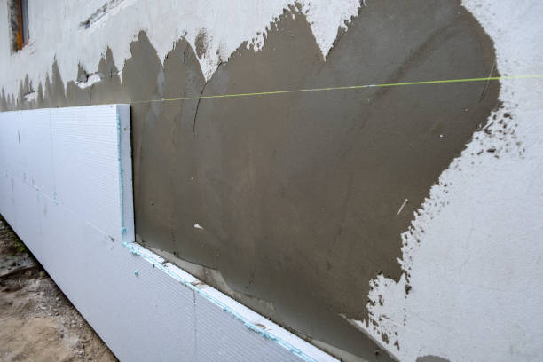 istock Installation of styrofoam insulation sheets on house facade wall for thermal protection. 1388322007