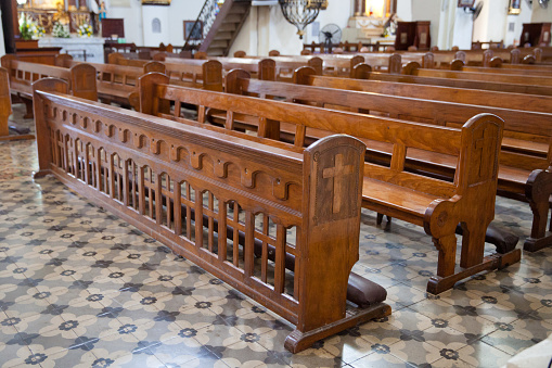 Bench in the catholic church. old wooden benches in the cathedral. The interior of the Philippine church.