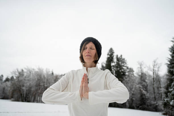 istock Young woman meditating outside 1388327953