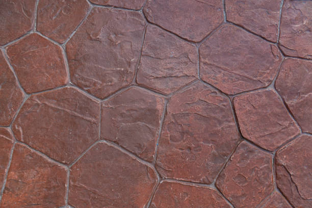 Cement floor is decorated with a stone crevice pattern painted in orange. stock photo
