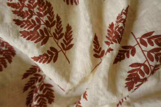 istock Rumpled beige linen fabric with brown fern leaves print 1388332012