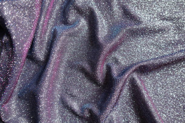 istock Draped shiny purple lurex fabric with pink and blue tinges 1388332071