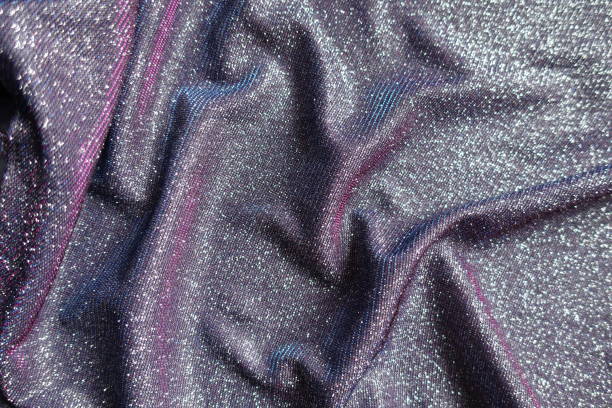 Draped shiny purple lurex fabric with pink and blue tinges Draped shiny purple lurex fabric with pink and blue tinges unprinted stock pictures, royalty-free photos & images