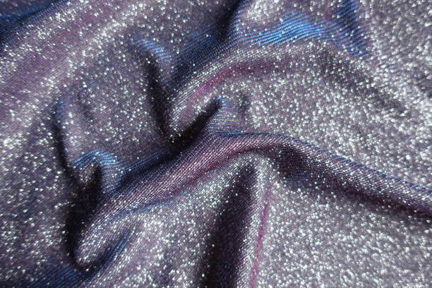istock Folded shiny purple lurex fabric with pink and blue tinges 1388332204