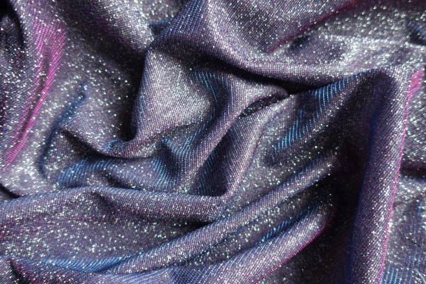 istock Rumpled shiny purple lurex fabric with pink and blue tinges 1388332255