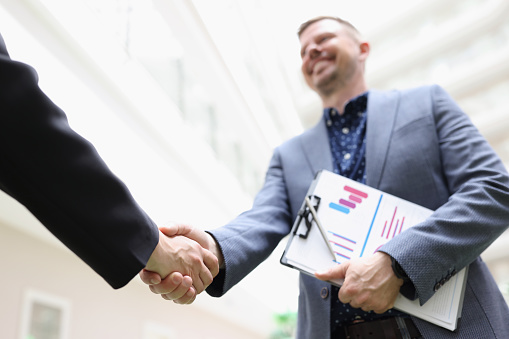 Close-up of partners shake hands, beneficial deal, successful agreement, biz partners perform friendly gesture. Agreement, career growth, success concept