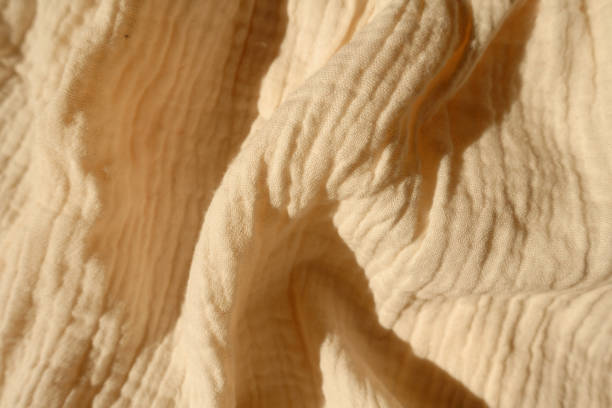 istock Draped thin pastel beige cotton muslin fabric 1388332528