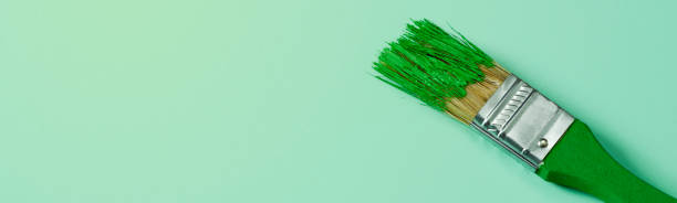 istock a green paintbrush with green paint, web banner 1388334562