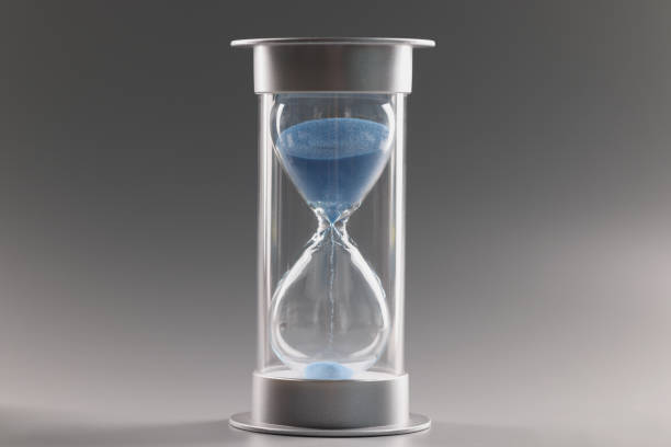 istock Measure passing time, countdown, blue sand running through bulbs of hourglass 1388334907