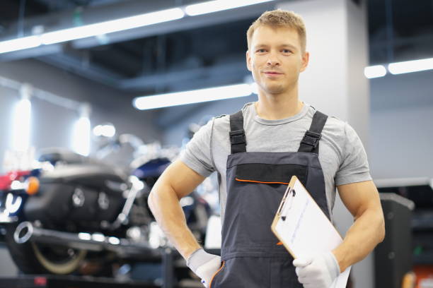 istock Qualified maintenance service worker in uniform, man with clipboard paper 1388337183