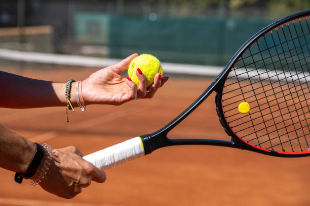 istock Hands holding racket and tennis ball 1388338506