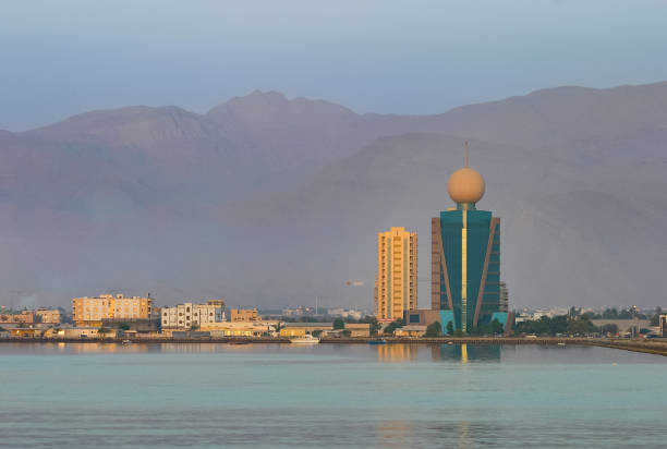 The Etisalat building, with its hallmark sphere, overlooks Ras al Khaimah's creek in the evening.