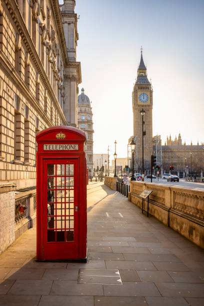 una classica cabina telefonica rossa di fronte alla torre dell'orologio del big ben a londra - england uk london england travel foto e immagini stock