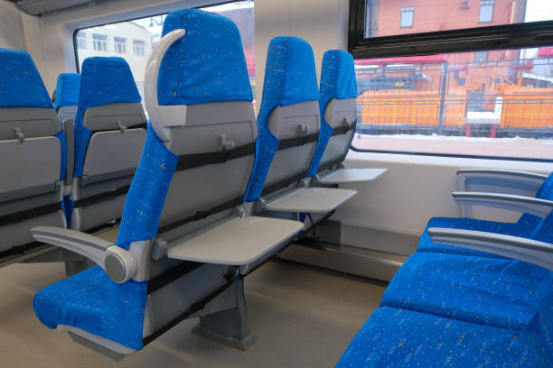 istock Chairs with folding tables in public transport. Seats in the commuter train. 1388340688